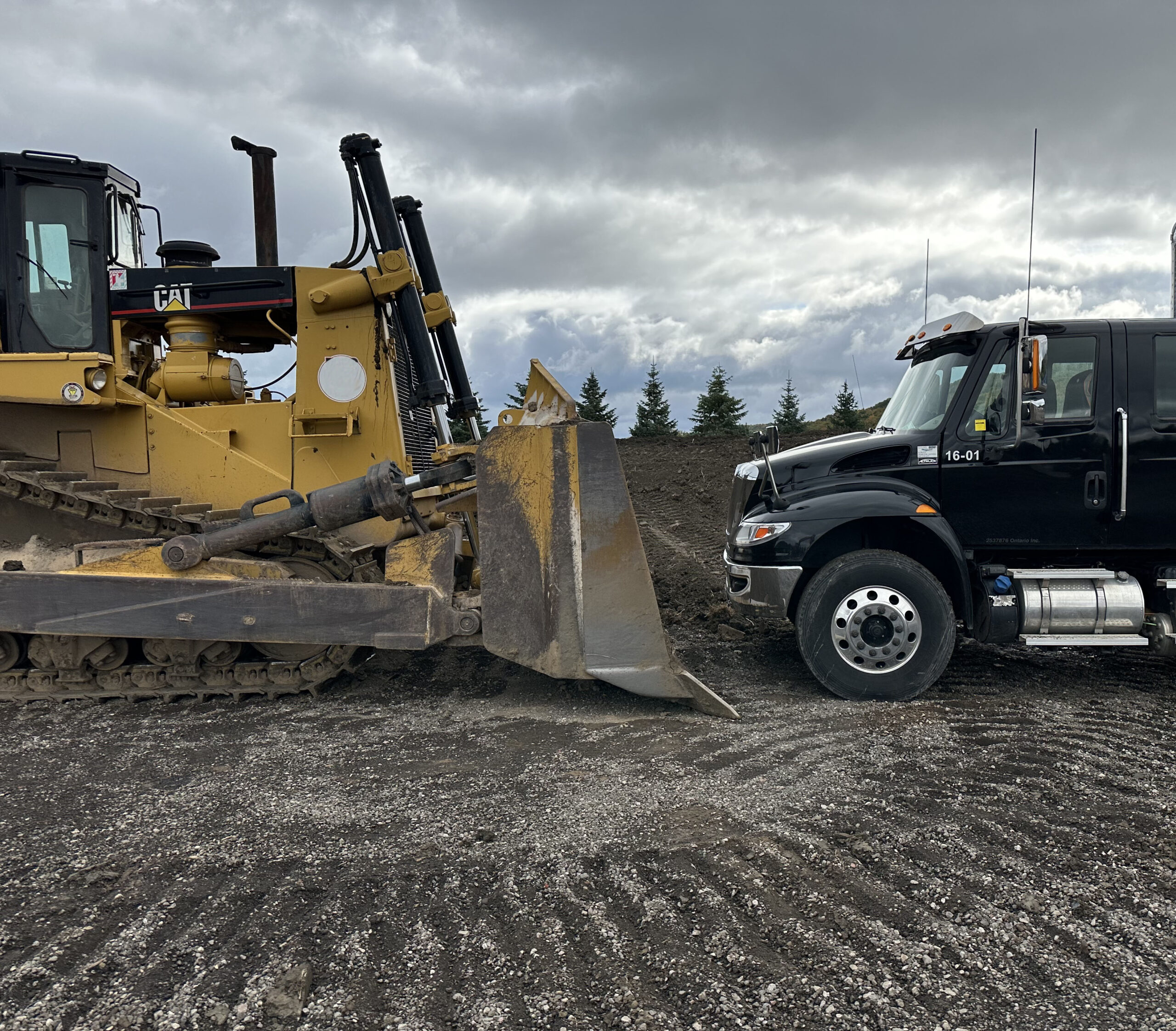 Mobile wash truck alongside a bulldozer at a jobsite